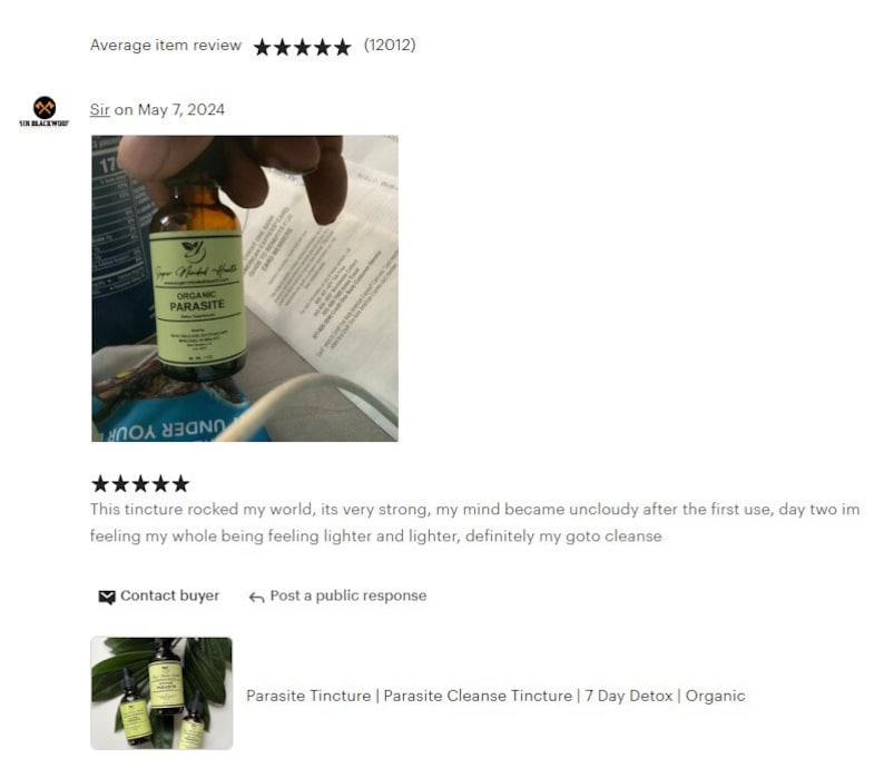 May include: A glass bottle with a brown liquid and a label that reads "Organic Parasite". The bottle is being held by a hand. The image is a product review for a parasite cleanse tincture.