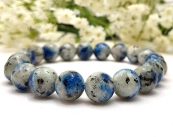 May include: A blue and white kyanite gemstone bracelet with round beads. The bracelet is made of natural stones and has a polished finish.