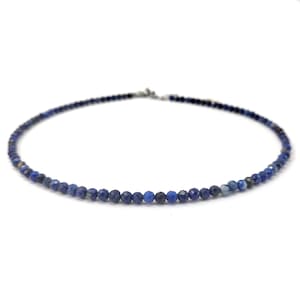 May include: A delicate necklace made of small, faceted lapis lazuli beads. The necklace is a deep blue color and has a simple, elegant design.
