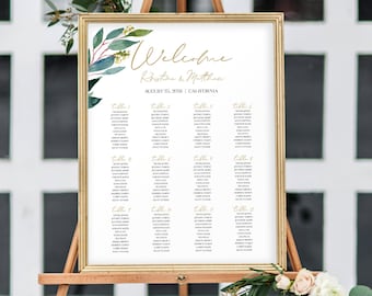 May include: A gold-framed wedding seating chart with a leafy green and burgundy floral design. The chart lists guest names by table number. The text reads "Welcome Kristin & Matthew August 24, 2018 | California".