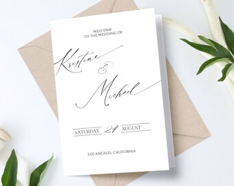 May include: A white wedding invitation with black calligraphy that reads "Welcome to the wedding of Kristine & Michael" with the date "Saturday 24 August" and the location "Los Angeles, California".