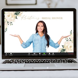 May include: A laptop screen displaying a virtual background for a bridal shower. The background features white flowers and greenery with the text "Kristine's Bridal Shower". A woman is in the center of the screen, smiling and holding her arms out.