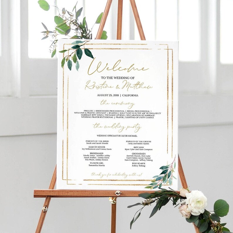 May include: A wedding ceremony program sign with a gold frame and green foliage. The sign includes the names Kristine and Matthew, the date August 25, 2018, and the location California. The sign also includes the wedding party names and roles.
