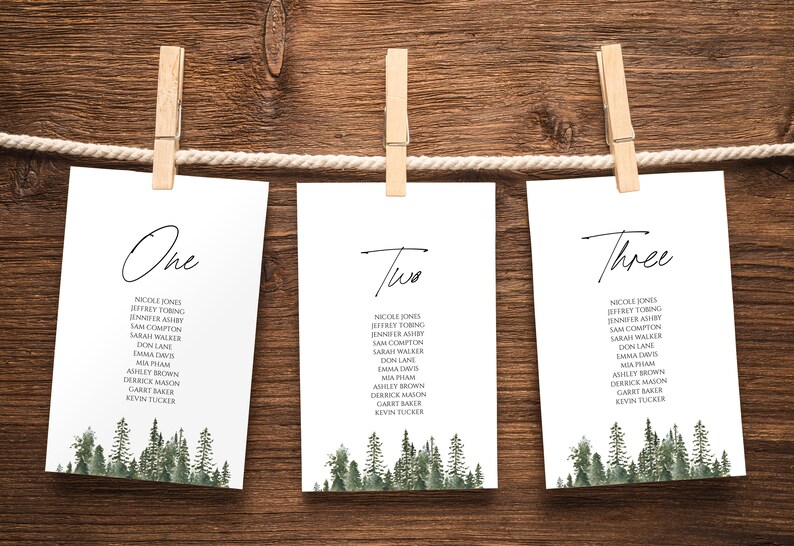 May include: Three white cards with black calligraphy numbers "One", "Two", and "Three" at the top. Each card lists a set of names in black text and has a watercolour illustration of a forest at the bottom.
