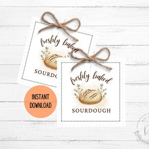 May include: Two square tags with watercolour illustrations of sourdough bread, tied with twine bows. The tags read "freshly baked SOURDOUGH" in elegant script. An orange circle with "INSTANT DOWNLOAD" is also visible.