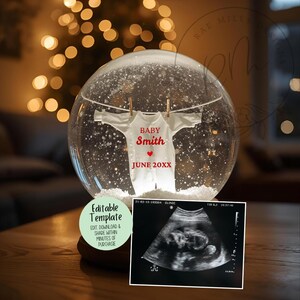 May include: A snow globe with a white onesie hanging inside, personalized with the name "Smith" and the date "June 20XX". Includes an ultrasound image and a green label that says "Editable Template".