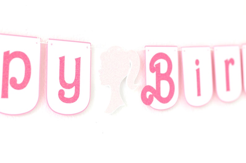May include: Pink and white banner with the words "Happy Birthday" and a white silhouette of a woman's head.