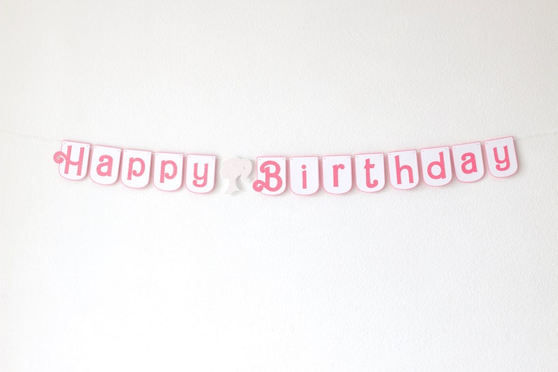 May include: Pink and white banner with the words "Happy Birthday" in pink letters.