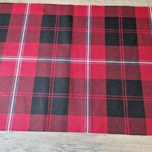 May include: Red and black plaid table runner with white and blue accents.