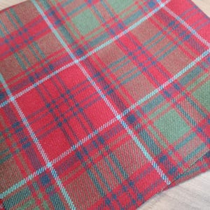 May include: Red, green, and blue plaid fabric with a woven texture.