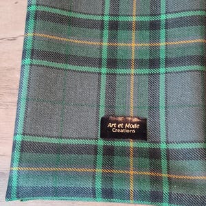 May include: Green, gray, and yellow plaid fabric with a black label that reads "Art et Mode Creations".