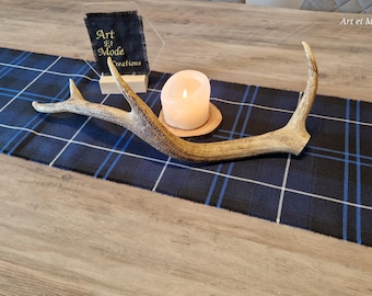 May include: A blue and white plaid table runner with a white candle and a set of antlers on top. The text "Art et Mode Creations" is visible in the upper right corner of the image.