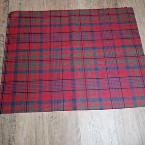 May include: Red, green, and blue plaid fabric with a woven texture.