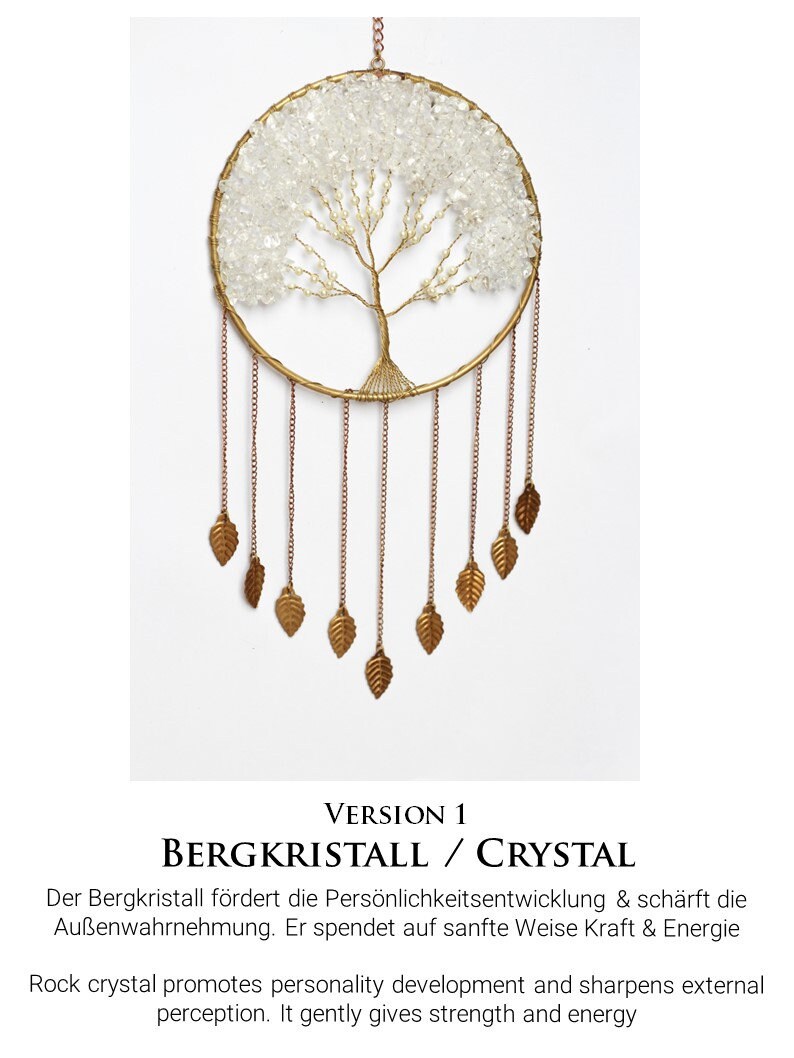 May include: A gold-toned metal dreamcatcher with a clear crystal tree design and gold leaf accents. The text "VERSION 1 BERGKRISTALL / CRYSTAL" is below the dreamcatcher. The text below reads "Der Bergkristall f&ouml;rdert die Pers&ouml;nlichkeitsentwicklung & sch&auml;rft die Au&szlig;enwahrnehmung. Er spendet auf sanfte Weise Kraft & Energie Rock crystal promotes personality development and sharpens external perception. It gently gives strength and energy"