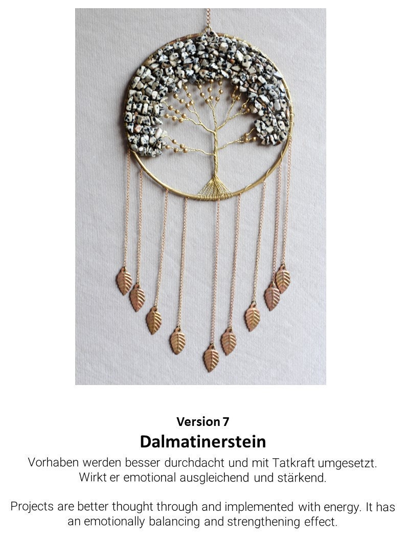 May include: A gold wire tree of life with a Dalmatian stone design. The tree is surrounded by a gold hoop and has gold chains with small gold leaves hanging from it. The text "Version 7 Dalmatinerstein" is below the image. The text below the image reads: "Vorhaben werden besser durchdacht und mit Tatkraft umgesetzt. Wirkt er emotional ausgleichend und st&auml;rkend. Projects are better thought through and implemented with energy. It has an emotionally balancing and strengthening effect."