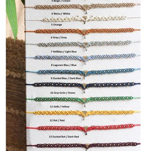 May include: A set of 14 colorful friendship bracelets with gold beads and a gold pendant. The bracelets are arranged in a vertical row, with the colors ranging from black to pink.