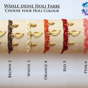 May include: Six colorful bracelets with gold leaf charms. The bracelets are arranged in a row from left to right: black, brown, white, orange, red, and pink. The text "CHOOSE YOUR HOLI COLOUR" is written above the bracelets.