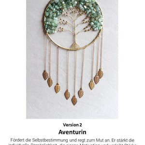 May include: A green aventurine crystal dreamcatcher with a wire tree design and gold leaf accents. The dreamcatcher is hanging from a chain with gold leaves at the bottom. The text "Version 2 Aventurin" is below the dreamcatcher.