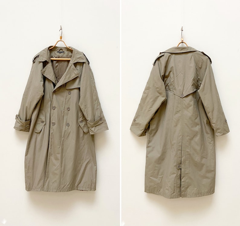 May include: A beige trench coat with a double-breasted closure and a belt. The coat has a classic design and is perfect for layering in the fall or spring.