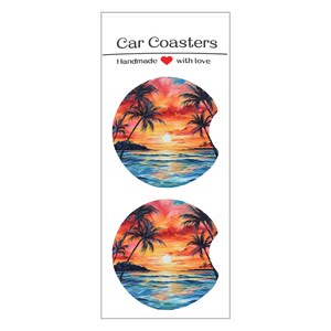 May include: Two car coasters with a tropical sunset design. The coasters feature a vibrant sunset over the ocean with palm trees. The text "Car Coasters" and "Handmade with love" are printed at the top.