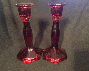 Pair of heavy red vintage glass candlestick holders