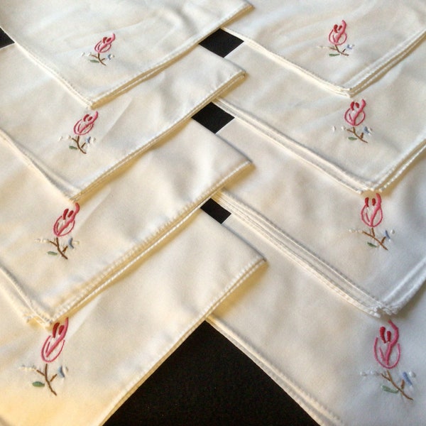 Eight immaculate white linen napkins hand embroidered with flowers