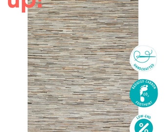 May include: A hand-woven rug with a striped pattern in shades of brown, beige, and white. The rug is made from recycled materials and has a reduced carbon footprint. The rug is also handcrafted and has low-end prices.
