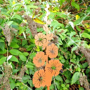 May include: A copper metal garden stake with a design of a flower stalk with multiple flowers. The flowers are cut out and have a delicate, intricate design.