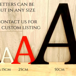 May include: Wooden letters in black, red, and white, with the letter "A" displayed in sizes from 10cm to 50cm. The image includes the text "LETTERS CAN BE CUT IN ANY SIZE CONTACT US FOR A CUSTOM LISTING."