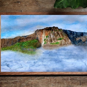 May include: Watercolor painting of a mountain range with a waterfall cascading down the side. The mountain is surrounded by clouds and a blue sky.