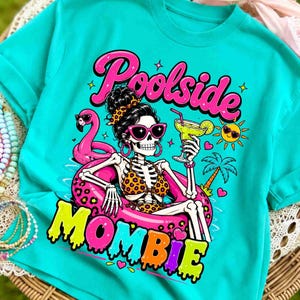 May include: Turquoise t-shirt with a graphic of a skeleton in sunglasses, a leopard print bikini, and a pink flamingo float. The text reads "Poolside Mombie."