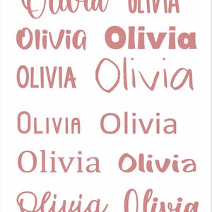 May include: A white background with the name "Olivia" in various pink fonts. The word "Olivia" is displayed in different styles, including cursive, block letters, and a rounded font.