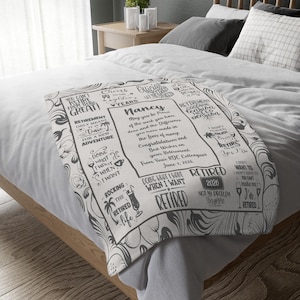 May include: A white and gray retirement blanket with text and illustrations. The blanket features phrases like "Retirement only means time for a new adventure" and "Doing what I want when I want." The name "Nancy" is also featured.
