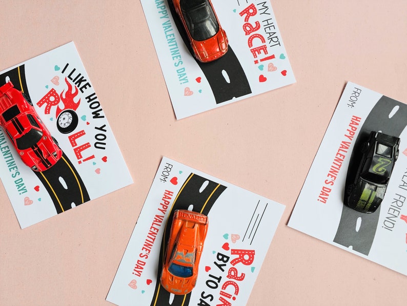 flat lay of hot wheels valentine cards printable assembled with toy cars on top.