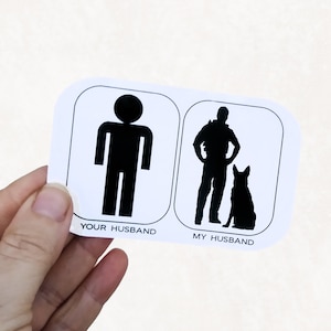 May include: White sticker with two black silhouettes. The left silhouette is a stick figure with the text "Your Husband". The right silhouette is a person with a dog, with the text "My Husband".