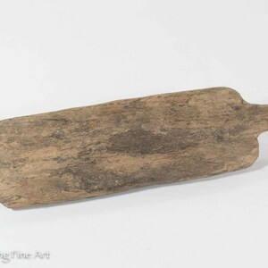 May include: A wooden paddle with a long handle. The paddle is worn and has a natural wood finish.