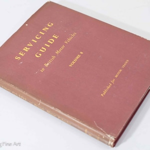 May include: A maroon book titled "Servicing Guide to British Motor Vehicles, Volume 8, Published for Motor Trader".