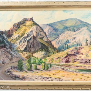 May include: Oil painting of a mountain landscape with a winding road. The artwork features a palette of greens, yellows, and blues, with a detailed depiction of the mountains and trees. The painting is framed in a gold-colored wooden frame.