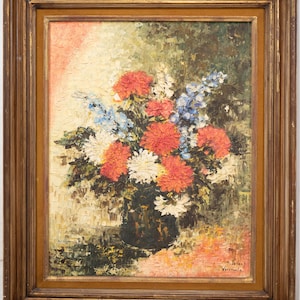 May include: An oil painting in a gold-toned wooden frame depicting a floral arrangement in a dark vase. The bouquet features textured red, white, and blue flowers against a mottled background. The artist's signature is visible in the bottom right corner.