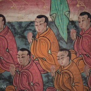 May include: A painting depicting eight figures in prayer, each wearing a robe with intricate patterns. The figures are arranged in a semi-circle, with their hands clasped in prayer. The background is a muted blue with hints of green and red.