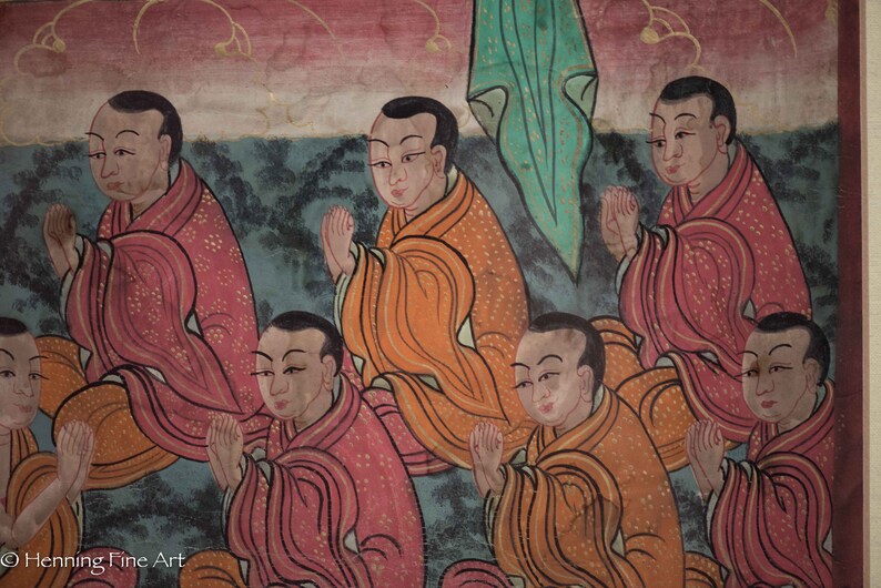 May include: A painting depicting eight figures in prayer, each wearing a robe with intricate patterns. The figures are arranged in a semi-circle, with their hands clasped in prayer. The background is a muted blue with hints of green and red.