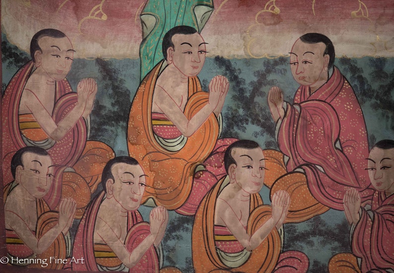 May include: A painting depicting a group of people in prayer. The people are wearing orange and red robes and have their hands clasped in front of them. The painting is done in a traditional style with a muted color palette.