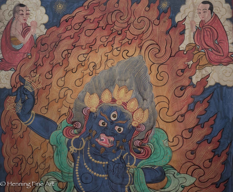 May include: A blue deity with three eyes and a fierce expression, surrounded by flames, is depicted in this traditional Tibetan painting. The deity is adorned with a crown of golden lotus flowers and a necklace of pearls. The painting is set against a background of swirling clouds and a blue sky.