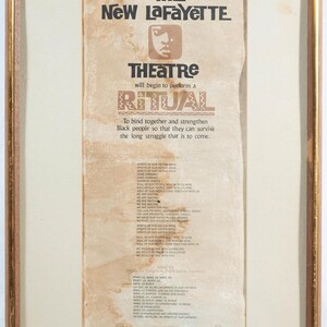 May include: Framed vintage poster for The New Lafayette Theatre, announcing a performance of "Ritual." The poster, with text in black, features a stylized face and symbols. The frame is gold-toned with a cream-colored mat.