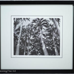 May include: A black and white ink drawing of palm trees in a black frame with a white mat. The artwork features detailed line work and stippling to create texture on the trunks and fronds. The print is signed and titled at the bottom edge.