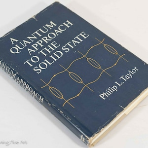 May include: A blue hardcover book titled "A Quantum Approach to the Solid State" by Philip L. Taylor. The cover features a stylized graphic design of overlapping circles and lines.