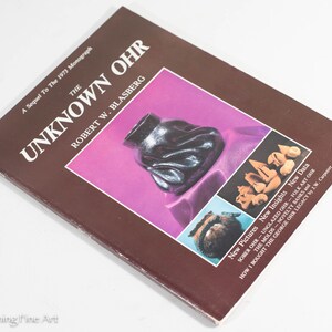 May include: A brown book titled "The Unknown Ohr" by Robert W. Blasberg. The book cover features images of pottery and a caption that reads "New Pictures, New Insights, New Data".
