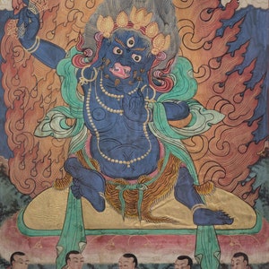 May include: A blue deity with three eyes and a fierce expression sits on a throne surrounded by flames. The deity is adorned with jewelry and a green scarf. Below, a group of people in orange and red robes are kneeling in prayer.