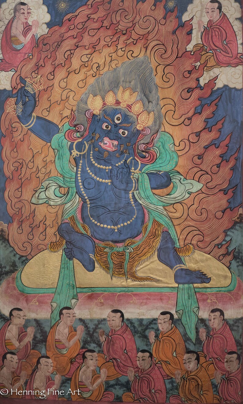 May include: A blue deity with three eyes and a fierce expression sits on a throne surrounded by flames. The deity is adorned with jewelry and a green scarf. Below, a group of people in orange and red robes are kneeling in prayer.
