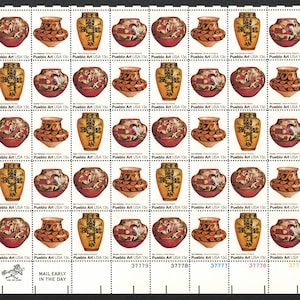 May include: A sheet of 25 US postage stamps featuring Pueblo Art. Each stamp depicts a different pottery design with geometric patterns and colors like red, orange, yellow, and black. The stamps are arranged in a 5x5 grid. The text "Pueblo Art USA 13c" appears on each stamp. The bottom row of stamps has the numbers 37779, 37778, 37777, 37776, and 37775.